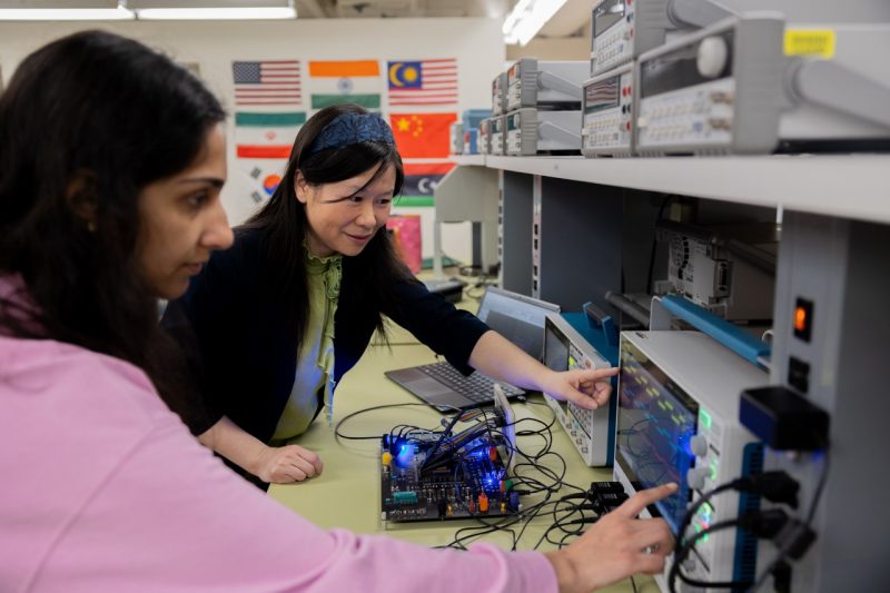 Yang (Cindy) Yi works with one of her graduate students in the MICS@Virginia Tech lab.