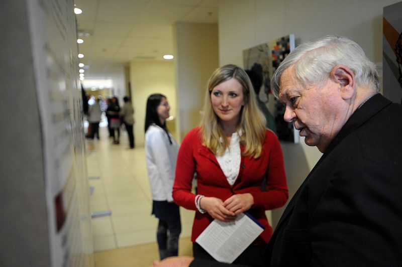 Carlie Blake, a member of the Class of 2015, and Dr. Harry Dorn, an assistant professor at the Virginia Tech Carilion Research Institute, study her poster presentation.