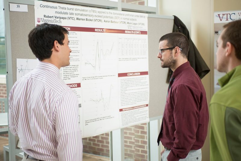 Robert Varipapa explains his research project to his fellow medical students.