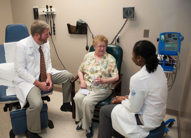 Dr. David Trinkle and Shareefah Stanley consult with a patient