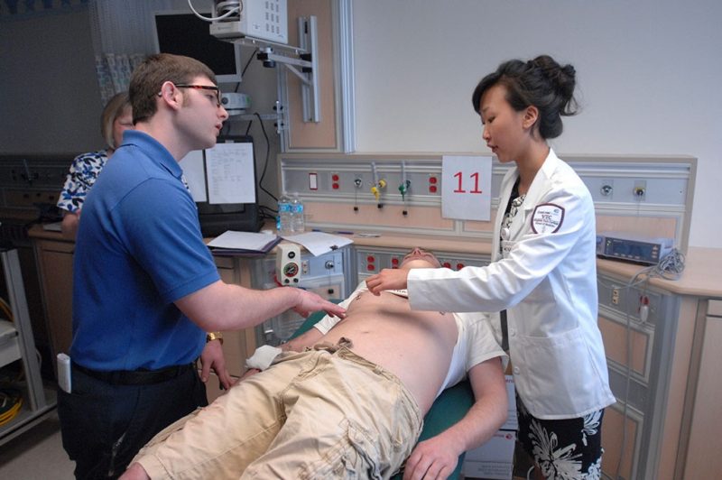 Student Sanghee Suh working with other healthcare professionals.