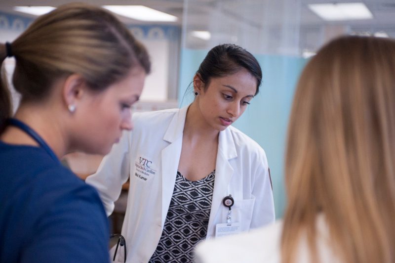 Nikki Kumar '16 works with her team to assess a patient's condition.
