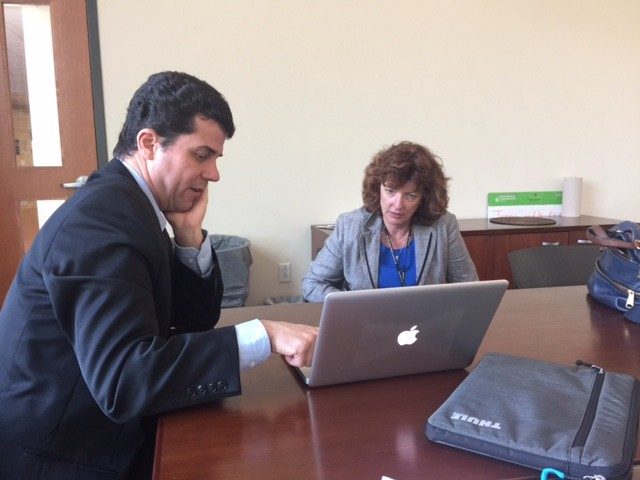 Dr. Gustavo Pinto visits with local newspaper reporter Luanne Rife.