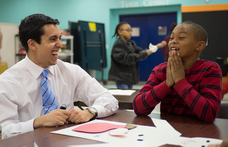 First year medical student Malek Bouzaher shares a laugh with a member of the Boys and Girls Club of Southwest Virginia.