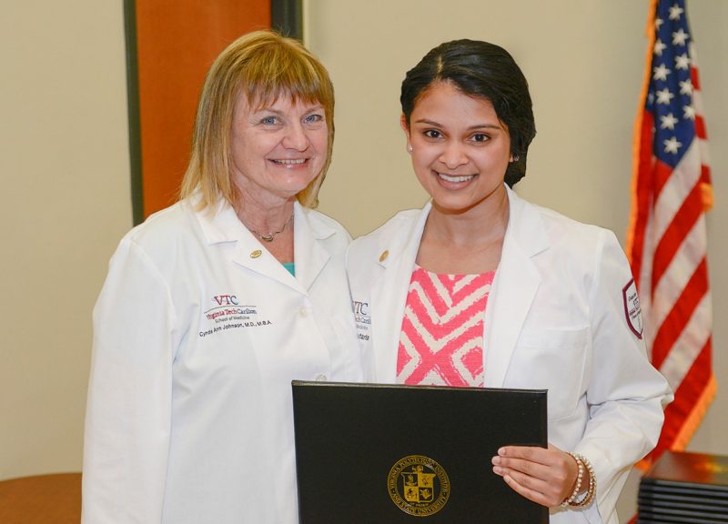 Dr. Cynda Johnson (left) and medical student Tarangi Sutaria (Class of 2017) of the Virginia Tech Carilion School of Medicine take part in the Student Clinician's Ceremony.