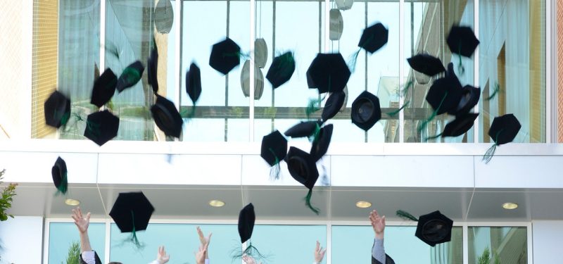 Members of the class of 2016 toss their tams in the air after graduation exercises of the Virginia Tech Carilion School of Medicine.