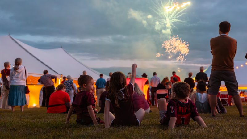 A group of children watch fireworks on the Drillfield