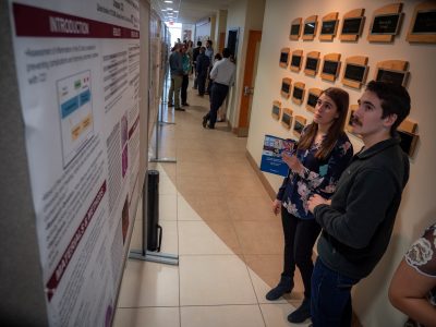 Man and woman looking at scientific poster