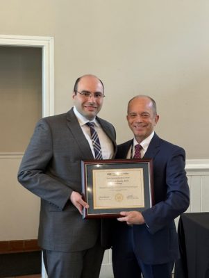 Dr. Aubrey Knight presenting to award winner Dr. Jonathan Saado.