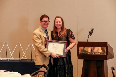 Dr. Uherick presenting award to Deans Academic Excellence Award winner Dr. Daniel Calick