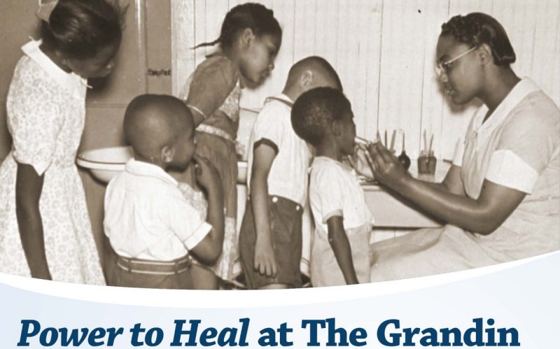 Power to Heal at the Grandin. Black and white photo of a black woman with three black boys and two black girls