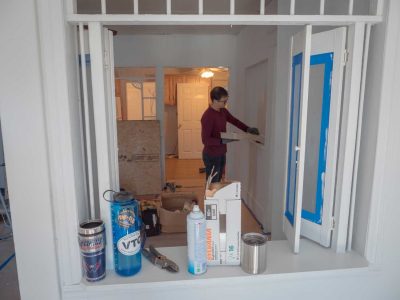 volunteer painting as viewed through an open window