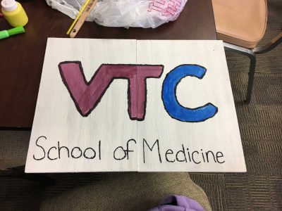 a hand-painted sign that reads VTC School of Medicine