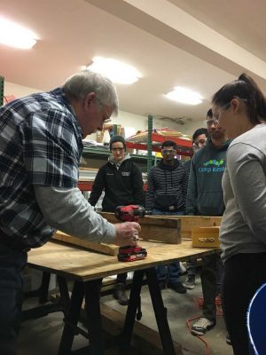 students receive instruction for using power tools