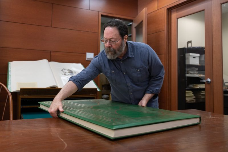 Marc Brodsky worked with unique materials in Special Collections and University Archives, including the 60 pound illustrated limited edition of John James Audubon's "Birds of America." Photo by Chase Parker for Virginia Tech.