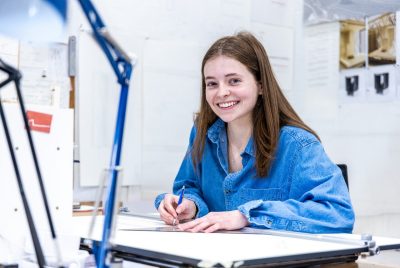 A student sits at a desk.