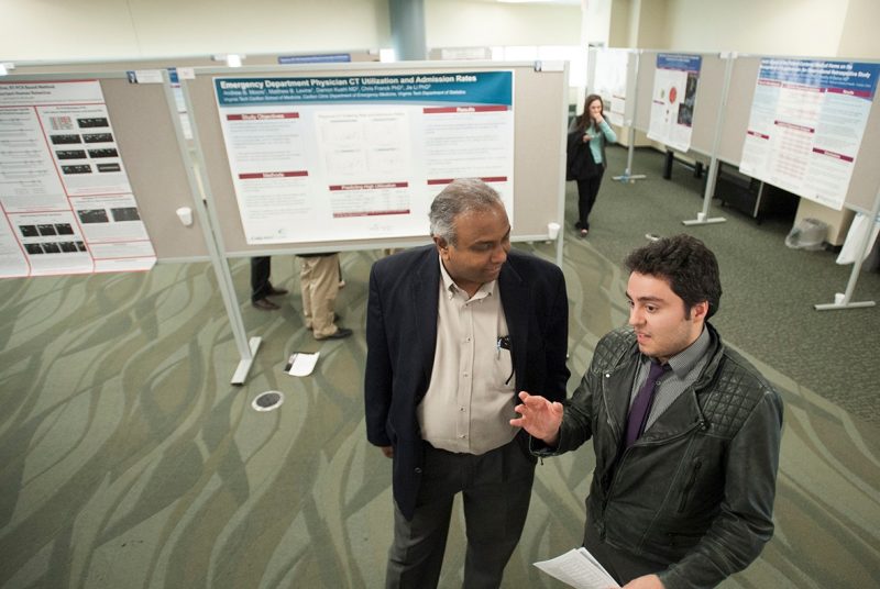  student Shervin Mirshahi discusses his research project with his mentor, Dr. Puneet Puri