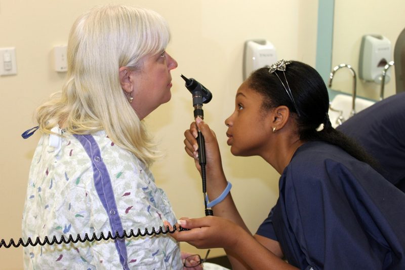 Camp Carilion participant checking the nose of a standardized patient