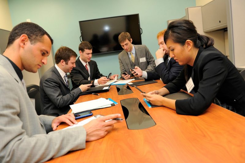 Group of students working around a conference table