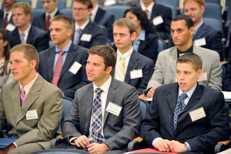 A group of male students listening to a presentation