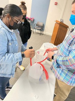 two Black students participate in an siphoning experiment