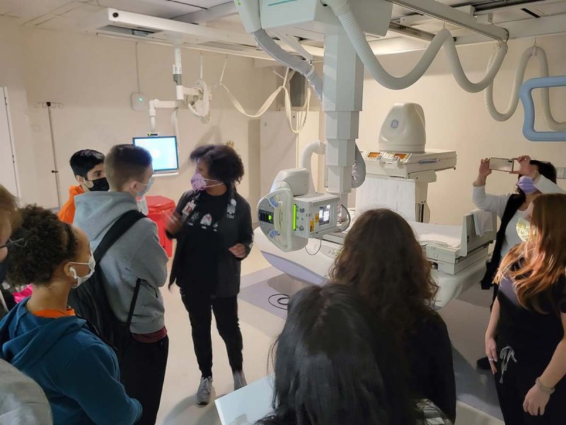 Group of racially diverse students and instructor in an imaging lab