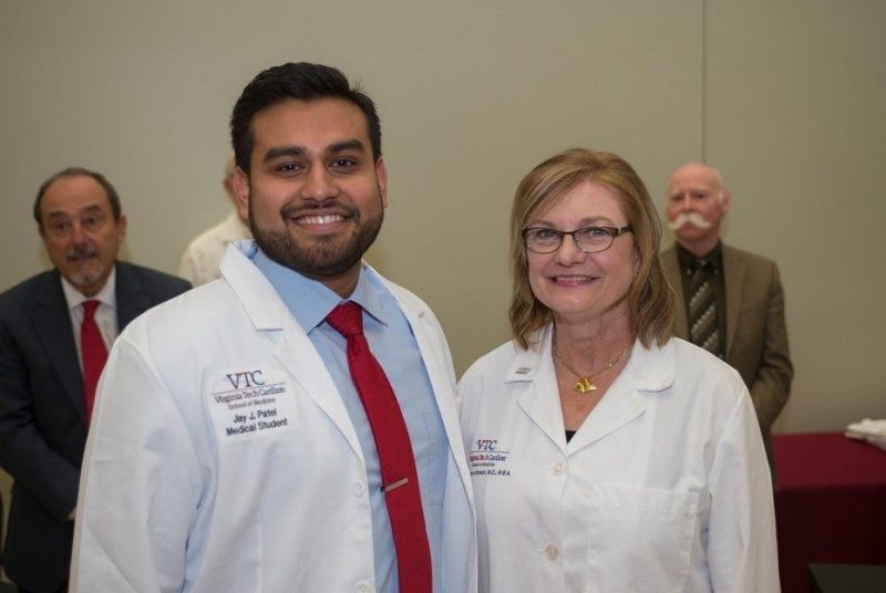 Jay Patel with founding dean Cynda Johnson. Drs. Vari and Nolan in the background