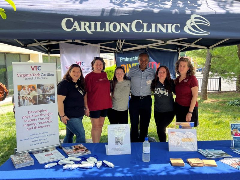 six people in a carilion clinic booth
