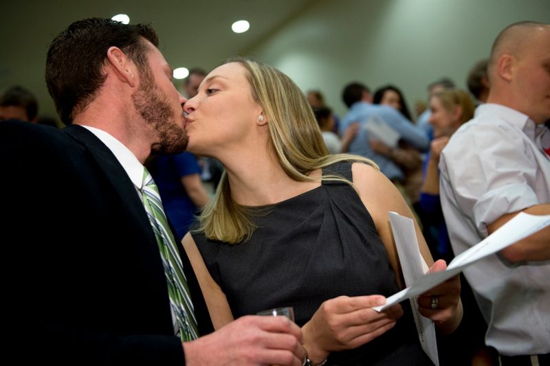 Elizabeth Glazier and her husband Daniel kiss as they celebrate her match