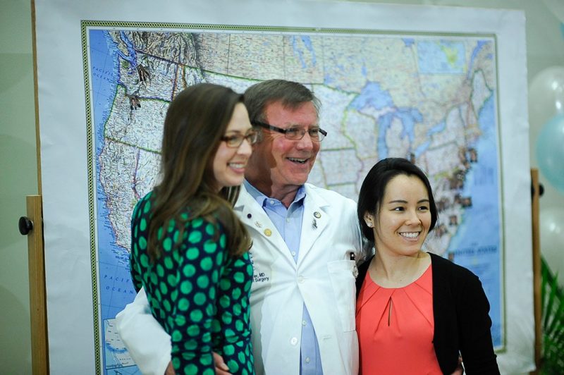 Chair of the Department of Surgery for Carilion Clinic and the Virginia Tech Carilion School of Medicine, Christopher "Chip" Baker, poses for pictures with Lauren Poindexter and Elizabeth Gilliam