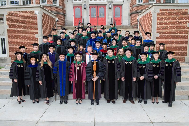 Faculty members at the Virginia Tech Carilion School of Medicine stand on the steps of the Jefferson Center prior to graduation.