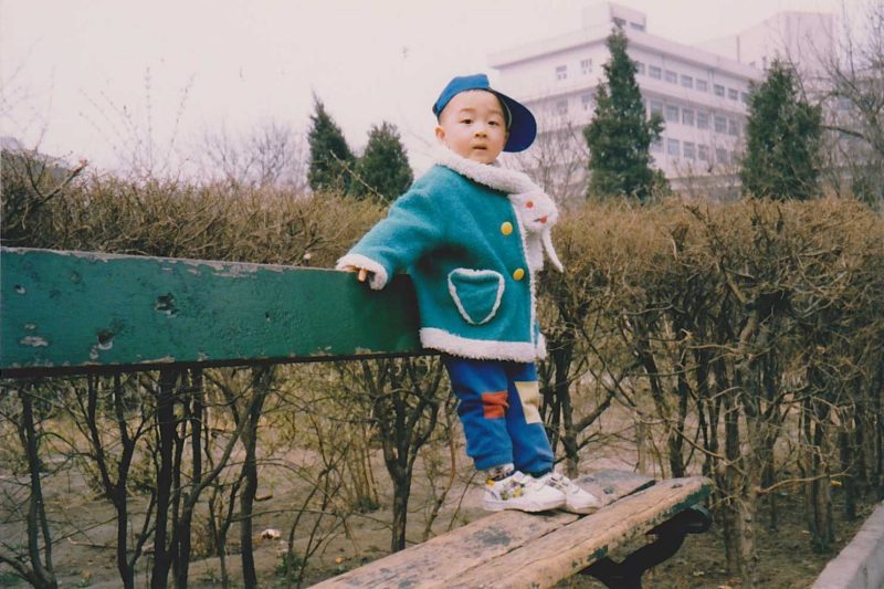Steve Qian on a bench as a child