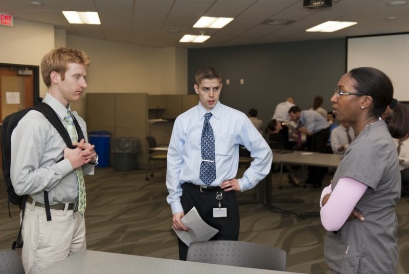 Josh Nichols (left) and Josh Eikenberg (middle) ask questions after an oral health workshop